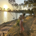 Brie standing by the water with her dog