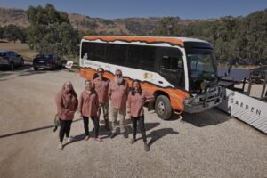 wawa biik team standing in front of bus