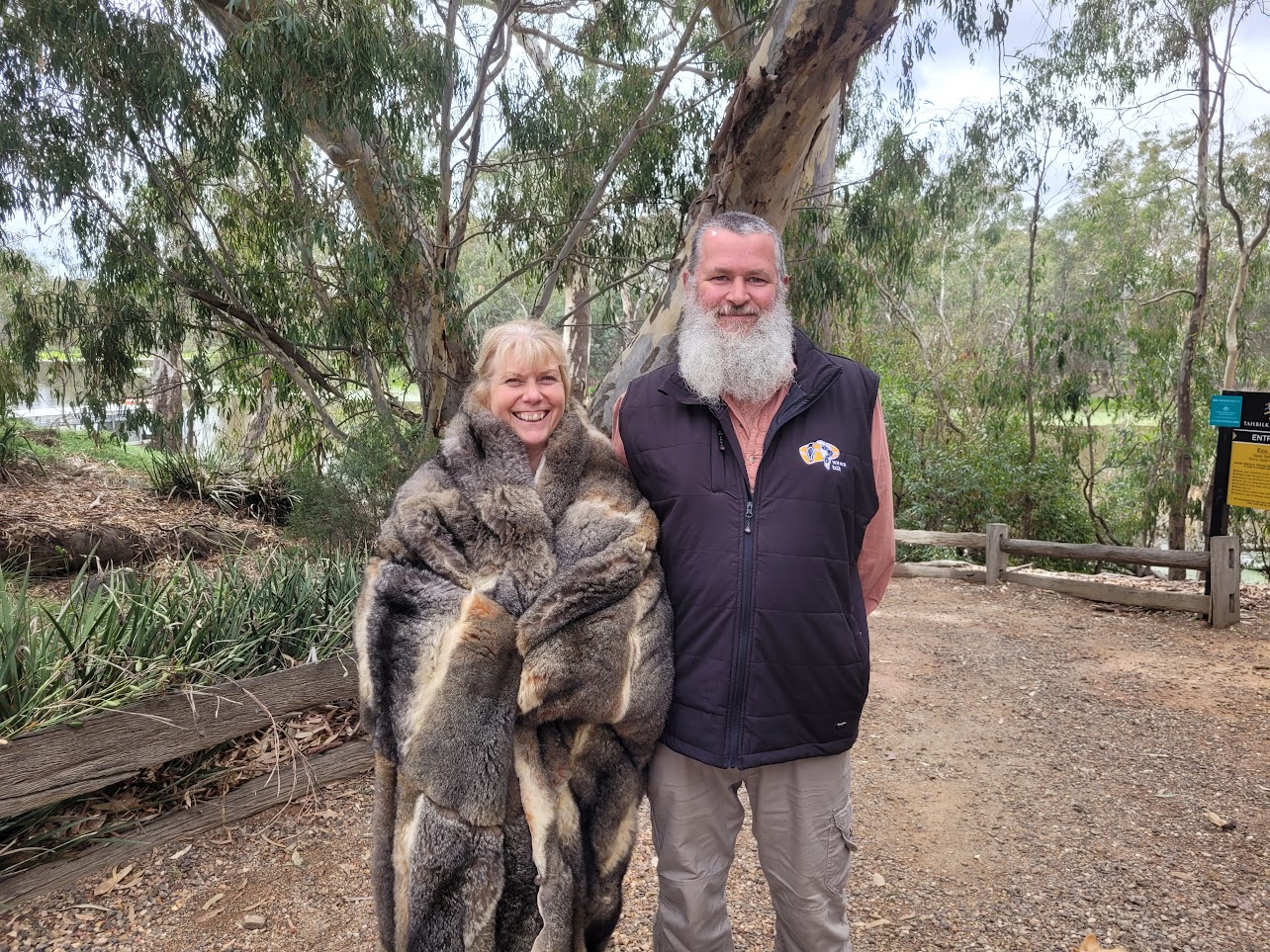Image of Deb in possum skin cloak standing with wawa biik guide
